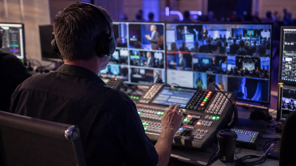 Director's console and monitors for restreaming a live broadcast
